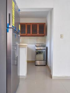a kitchen with a stove and a refrigerator at Lovely and peaceful stay in San Pedro de Macorís