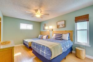 a bedroom with two beds and a ceiling fan at Panama City Beach Home Steps to the Ocean! in Panama City Beach