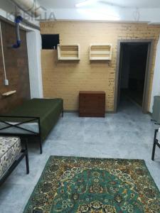 a room with a bed and a rug on the floor at Фэмили хостел in Almaty