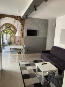 a living room with a couch and a table at Apartament Natalia in Mrągowo