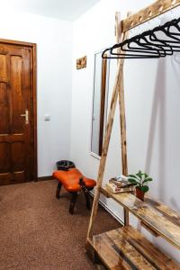 a room with a ladder and a chair and a mirror at Casa Rosu in Cluj-Napoca