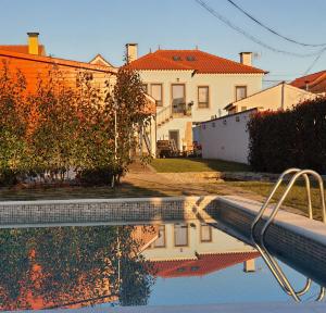 a house and a swimming pool in front of a house at Alvorada Medieval, AL in Valença