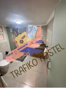 a bathroom with a painting of a plane on the wall at Trafiko in Cairo