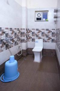 a bathroom with a toilet and a sink at Classe Moyenne -2BHK, Near US Embassy, Gachibowli in Hyderabad