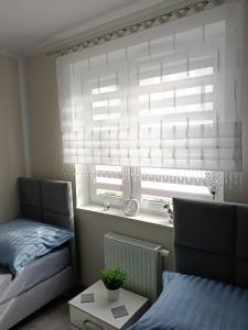 Posteľ alebo postele v izbe v ubytovaní Apartament Zielony Zakątek Wrocław free parking, ochrona