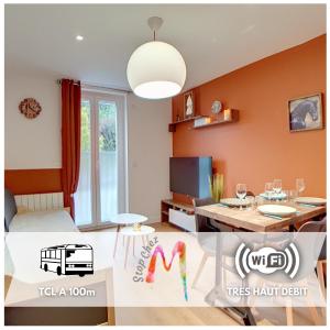a living room with a bed and a dining room at Stop Chez M Select Saga # Qualité # Confort # Simplicité in Saint-Fons