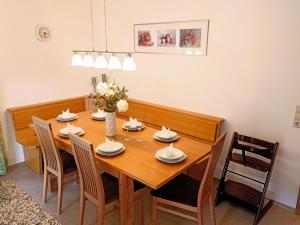 a dining room with a wooden table and chairs at Apartment Schmidt - VNN140 by Interhome in Vandans