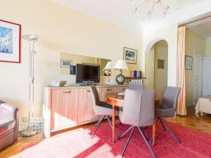 sala de estar con mesa con sillas y TV en Apartment La Floride Promenade des Anglais by Interhome, en Niza