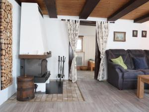 a living room with a couch and a fireplace at Holiday Home Haus Schwärzel by Interhome in Neuried