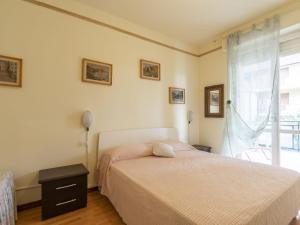 a bedroom with a bed and a window at Apartment Fulvia by Interhome in Santo Stefano al Mare