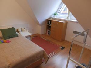 a bedroom with a bed and a dresser and a window at Apartment Peter in Donovaly