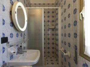 a bathroom with a sink and a shower with a mirror at Apartment Capriolo by Interhome in Sanremo