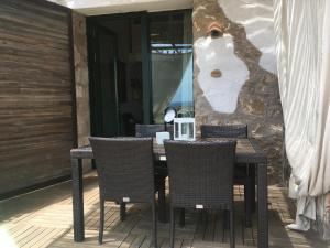 a dining table and chairs on a patio at Residenza A Cova in Carloforte