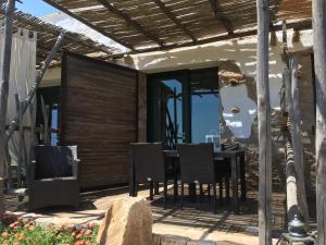 a patio with a table and chairs on a house at Residenza A Cova in Carloforte