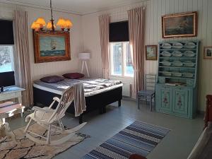 a bedroom with a bed and a chair in it at Holiday Home Elfvik by Interhome in Porvoo