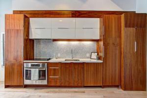 a kitchen with wooden cabinets and a sink at Le Merrill - Vieux Montréal in Montreal