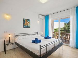 a bedroom with a bed with blue towels on it at Holiday Home El Gazebo by Interhome in Fanadix