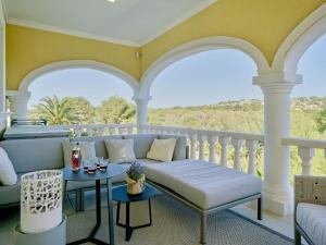 a porch with a couch and tables on a balcony at Villa Villa Ewa by Interhome in Jávea