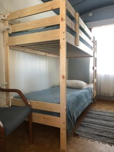 a wooden bunk bed in a room with a chair at Rena Hostel in Rena