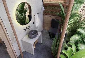 a bathroom with a sink and a mirror and some plants at OYA - Wellness Eco Resort & Retreat in Jamao al Norte