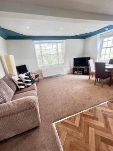 a living room with a couch and a table at Jasper Apartment in Lyme Regis