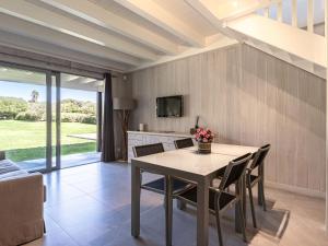 a dining room with a table and chairs at Apartment Le studio du Domaine le Petit Sperone by Interhome in Bonifacio