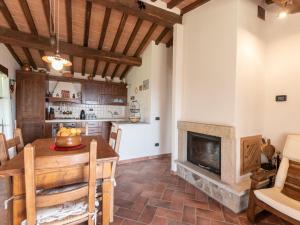 a living room with a table and a fireplace at Holiday Home Dimora del Re by Interhome in Sassofortino +17 photos