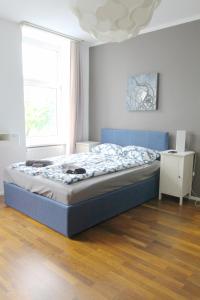 a bedroom with a blue bed in a room at W Apartment - Brigittenau Area MM15 in Vienna