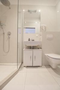 a white bathroom with a sink and a toilet at W Apartment - Brigittenau Area MM15 in Vienna