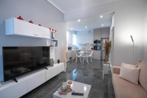 a living room with a large television and a couch at Neo Irakleio train st. 1 bedrm 4 pers. apartment in Athens