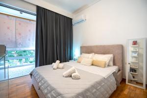 a bedroom with a bed with two pillows on it at Neo Irakleio train st. 1 bedrm 4 pers. apartment in Athens