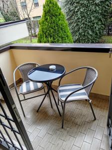 a small table and two chairs on a balcony at Elisa's House, Una coccola! in Castel San Pietro Terme