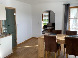 a kitchen and dining room with a table and chairs at Ferienwohnung Moser in Hauzenberg