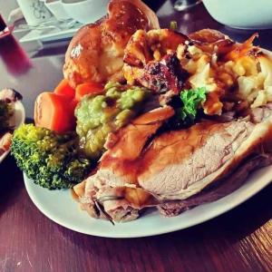 a plate of food with meat and vegetables on a table at The Bay Horse Hotel Wolsingham in Wolsingham