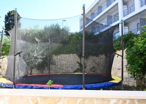 a bird is sitting on a trampoline at Hvar Villa Malisko Apartments in Hvar