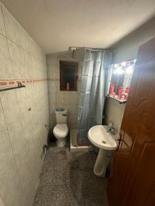 a small bathroom with a toilet and a sink at Villa Anna in Sarandë