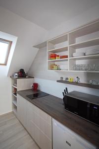 A kitchen or kitchenette at Paloznak Lux Apartmanház