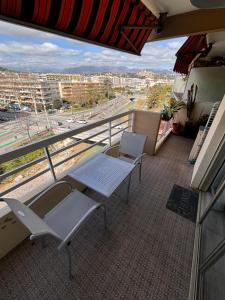 a balcony with chairs and a view of a city at Provencal in Cagnes-sur-Mer