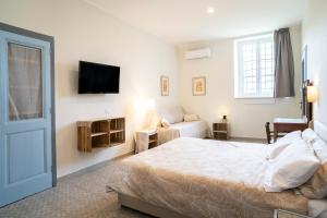 a bedroom with a bed and a tv on the wall at Riobasco in Albisola Superiore