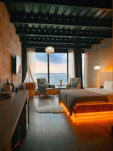 a bedroom with a bed with a view of the ocean at Marina Fener Hotel & Suite in Istanbul