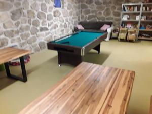 a room with a pool table and a couch at Gästehaus Samira in Purbach am Neusiedlersee