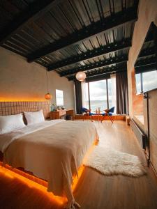 a bedroom with a large bed and a large window at Marina Fener Hotel & Suite in Istanbul