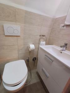 a bathroom with a white toilet and a sink at SAN MARCO in Bari