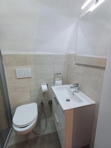 a bathroom with a white toilet and a sink at SAN MARCO in Bari