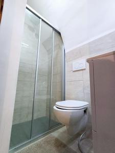 a bathroom with a toilet and a glass shower at SAN MARCO in Bari