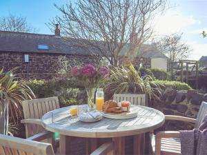 uma mesa com um prato de comida e sumo de laranja em Craster Reach em Alnwick