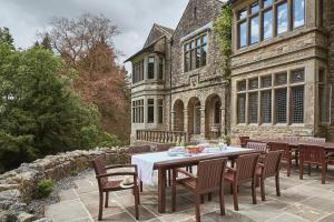 a table and chairs in front of a building at Oughtershaw Hall in Skipton