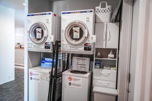 una lavanderia con due lavatrici e altri elettrodomestici di Hotel Imagine Kyoto a Kyoto