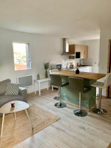 eine Küche und ein Wohnzimmer mit einem Tisch und Stühlen in der Unterkunft Casanostra - T3 avec terrasse proche de Cassis in Roquefort-la-Bédoule