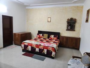 a bedroom with a bed in a room at Shri Achyutam Villa - Offering Best Value in Vrindavan in Vrindāvan